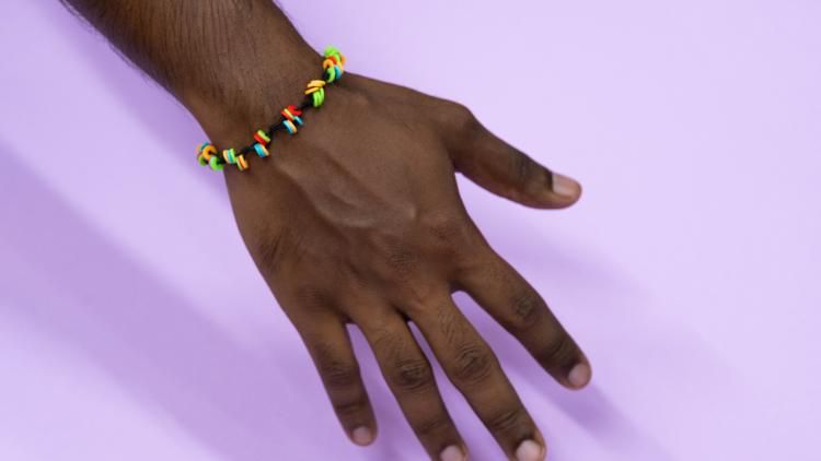 A hand wearing a bracelet